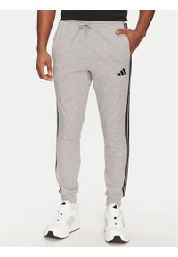Adidas - adidas Spodnie dresowe Essential 3-Stripes JE6346 Szary Regular Fit. Kolor: szary. Materiał: bawełna, syntetyk #1