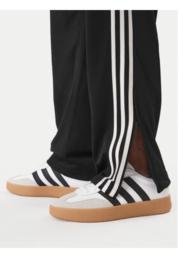 Adidas - adidas Spodnie dresowe Firebird KD8315 Czarny Loose Fit. Kolor: czarny. Materiał: syntetyk