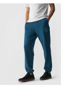 4f - Spodnie dresowe joggery męskie - turkusowe. Kolor: turkusowy. Materiał: dresówka. Wzór: napisy