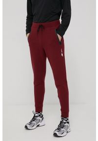 New Balance spodnie dresowe MP11143GTH męskie kolor bordowy melanżowe. Kolor: czerwony. Materiał: dresówka. Wzór: melanż #1