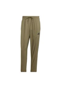 Adidas - Spodnie Essentials 3-Stripes Stanford Open Hem. Kolor: wielokolorowy, beżowy, czarny. Materiał: materiał