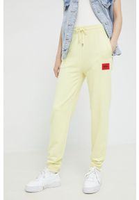Hugo - HUGO spodnie damskie kolor żółty gładkie. Kolor: żółty. Materiał: dzianina. Wzór: gładki