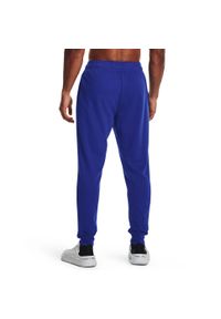 Spodnie dresowe męskie Under Armour Rival Terry Jogger. Kolor: niebieski. Materiał: dresówka