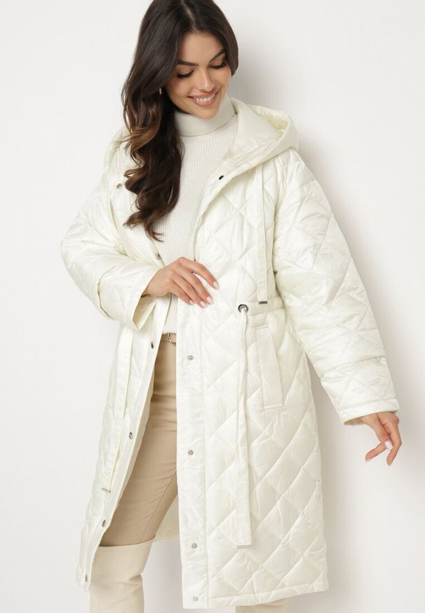 Born2be - Jasnobeżowa Pikowana Kurtka o Długim Kroju z Kapturem Paskiem i Ściągaczami w Talii Nikiana. Okazja: na co dzień. Typ kołnierza: kaptur. Kolor: beżowy. Materiał: jeans. Długość: długie. Styl: elegancki, casual, sportowy, klasyczny