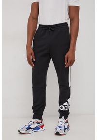 Adidas - adidas Spodnie męskie kolor czarny z nadrukiem. Kolor: czarny. Materiał: materiał. Wzór: nadruk