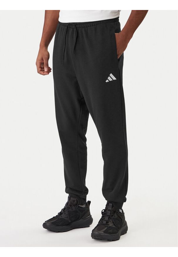 Adidas - adidas Spodnie dresowe Essentials Feel Cozy JE3854 Czarny Regular Fit. Kolor: czarny. Materiał: syntetyk, bawełna