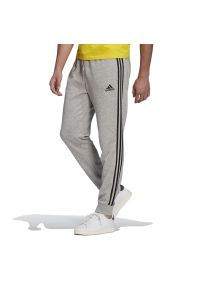 Adidas - Spodnie adidas Essentials French Terry Tapered Cuff 3-Stripes Pants GK8889 - szare. Kolor: szary. Materiał: dresówka, wiskoza, bawełna, tkanina, poliester. Wzór: aplikacja