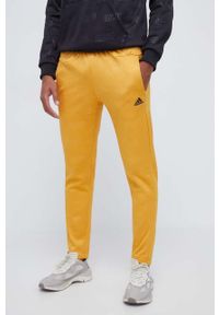 Adidas - adidas spodnie dresowe kolor żółty wzorzyste. Kolor: żółty. Materiał: dresówka #1