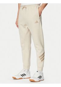 Adidas - adidas Spodnie dresowe Future Icons 3-Stripes KD5206 Beżowy Regular Fit. Kolor: beżowy. Materiał: bawełna #1