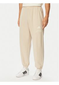 Adidas - adidas Spodnie dresowe Seasonal Essentials Collegiate French Terry Cuffed KF4265 Beżowy Regular Fit. Kolor: beżowy. Materiał: bawełna #1
