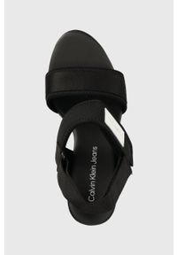 Calvin Klein Jeans sandały WEDGE SANDAL BADGE damskie kolor czarny na koturnie YW0YW01028. Zapięcie: rzepy. Kolor: czarny. Materiał: materiał, guma. Wzór: gładki. Obcas: na koturnie #3