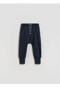 Reserved - Dresowe spodnie - granatowy. Kolor: niebieski. Materiał: dresówka #1