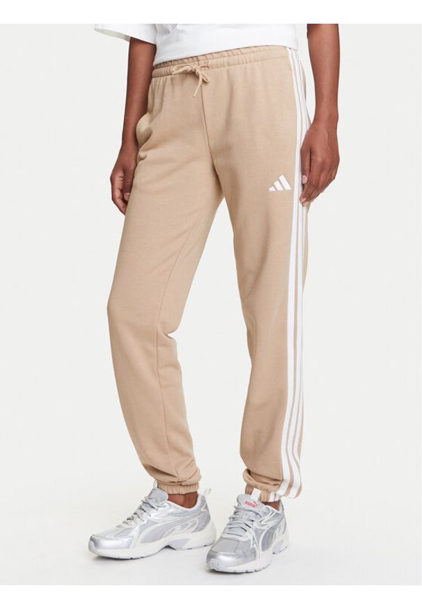 Adidas - adidas Spodnie dresowe Essentials 3-Stripes JX7661 Beżowy Regular Fit. Kolor: beżowy. Materiał: bawełna