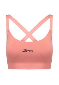 Reebok X Victoria Beckham - Top REEBOK X VICTORIA BECKHAM SEAMLESS BRA. Kolor: różowy. Materiał: elastan, tkanina. Długość rękawa: na ramiączkach. Wzór: gładki. Styl: sportowy #1