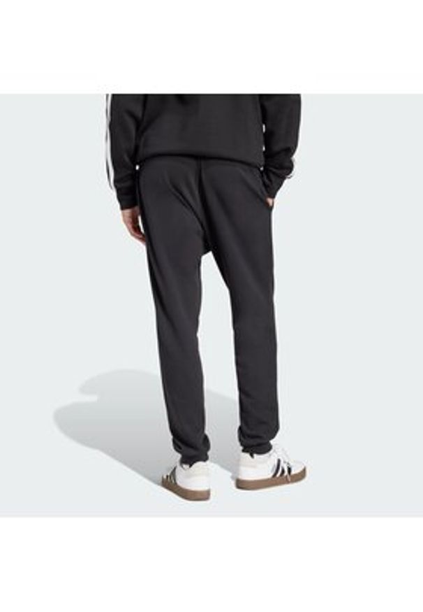 Adidas - adidas Spodnie dresowe Essentials Feel Cozy JE3854 Czarny Regular Fit. Kolor: czarny. Materiał: bawełna