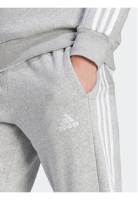 Adidas - adidas Spodnie dresowe Essentials Fleece 3-Stripes Cuff IJ6494 Szary Regular Fit. Kolor: szary. Materiał: dresówka, bawełna