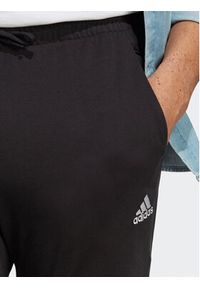 Adidas - adidas Spodnie dresowe Essentials Single Jersey Tapered Elasticized Cuff Logo Joggers IC0055 Czarny Regular Fit. Kolor: czarny. Materiał: bawełna