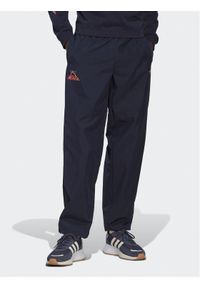 Adidas - adidas Spodnie dresowe Adventure Ride HK4979 Granatowy Loose Fit. Kolor: niebieski. Materiał: syntetyk, dresówka #1