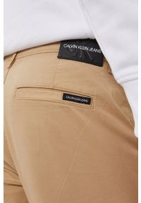 Calvin Klein Jeans Spodnie męskie kolor beżowy dopasowane. Kolor: beżowy. Materiał: tkanina #3