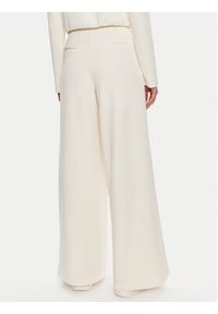 Guess Spodnie dresowe Olympe V4YB07 KCAY2 Beżowy Relaxed Fit. Kolor: beżowy. Materiał: syntetyk #2