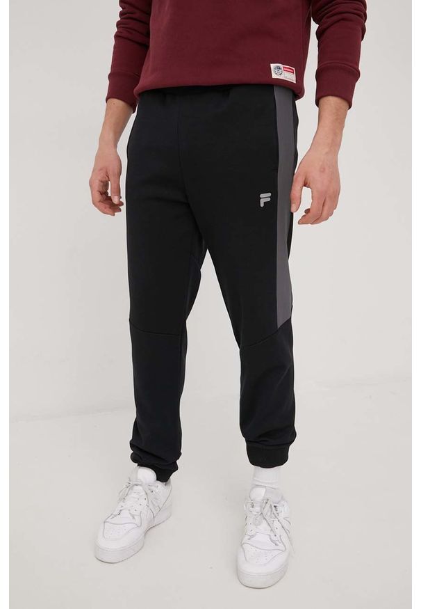 Fila spodnie dresowe męskie kolor czarny melanżowe. Kolor: czarny. Materiał: dresówka. Wzór: melanż