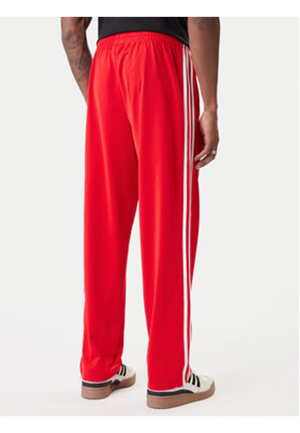Adidas - adidas Spodnie dresowe Firebird KD8319 Czerwony Loose Fit. Kolor: czerwony. Materiał: syntetyk