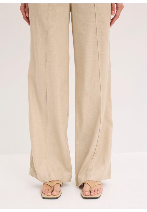 bonprix - Spodnie palazzo z przewiewnej mieszanki lnu. Kolor: beżowy. Materiał: len