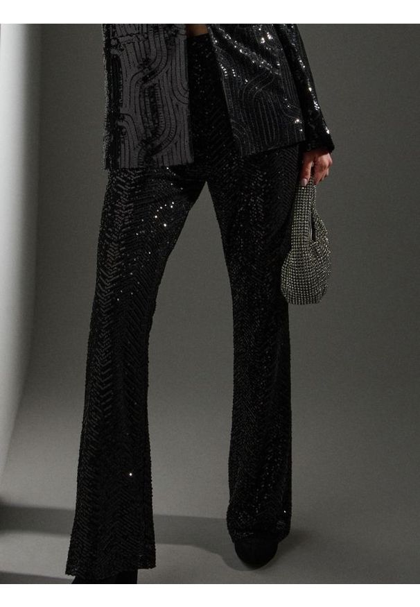 Sinsay - Spodnie dzwony z połyskującymi cekinami - czarny. Kolor: czarny