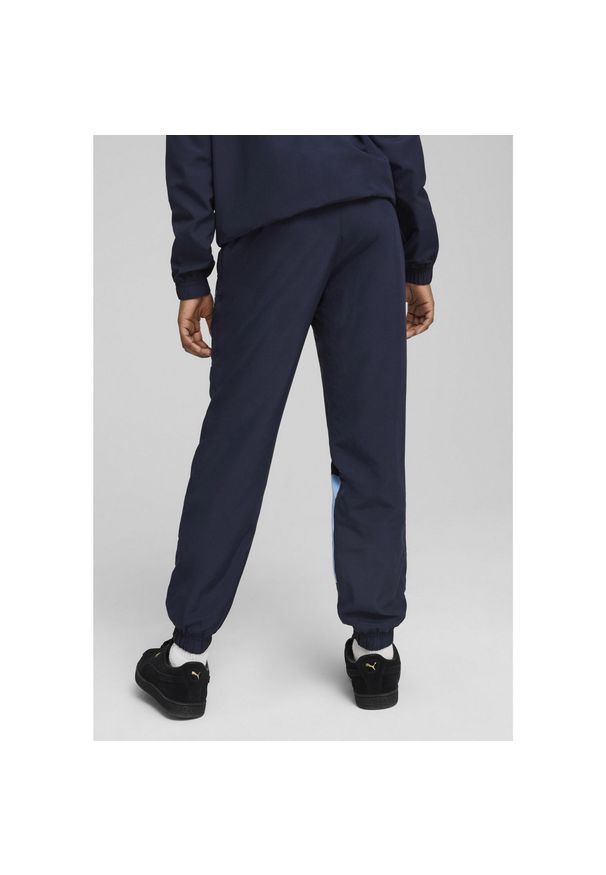 Puma - Młodzieżowe spodnie Manchester City ftblARCHIVE PUMA Navy Team Light Blue. Kolor: niebieski