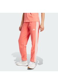 Adidas - Spodnie Essentials 3-Stripes French Terry Cuffed. Kolor: żółty, pomarańczowy, biały, wielokolorowy. Materiał: materiał. Sport: fitness #1