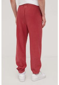 Champion spodnie dresowe męskie kolor różowy gładkie. Kolor: różowy. Materiał: dresówka. Wzór: gładki