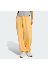 Adidas - Spodnie Soft Lux Loose. Kolor: pomarańczowy. Sport: fitness #1