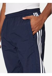 Adidas - adidas Spodnie dresowe Adibreak JD4258 Granatowy Loose Fit. Kolor: niebieski. Materiał: syntetyk #5