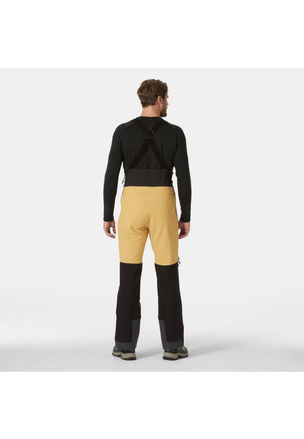 Spodnie narciarskie z szelkami Helly Hansen Odin BC Softshell. Kolor: beżowy, żółty, wielokolorowy. Materiał: softshell. Sezon: zima. Sport: narciarstwo