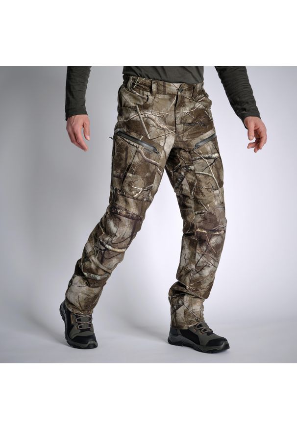 SOLOGNAC - Spodnie myśliwskie Solognac Warm 900 camo treemetic wodoodporne. Kolor: zielony, brązowy, wielokolorowy. Materiał: polar, materiał, tkanina, skóra. Sport: outdoor