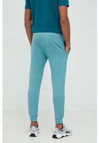 Guess spodnie dresowe kolor niebieski melanżowe. Kolor: niebieski. Materiał: dresówka. Wzór: melanż #2