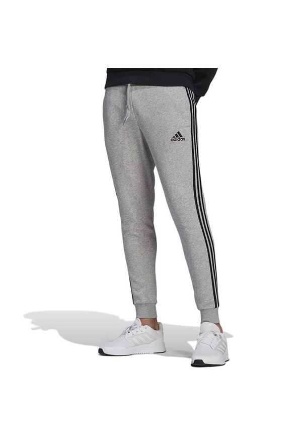 Adidas - Spodnie adidas Essentials Slim 3-Stripes GM1091 - szare. Kolor: szary. Materiał: bawełna, dresówka, poliester, wiskoza