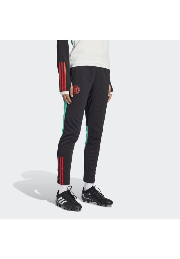 Adidas - Manchester United Tiro 23 Training Pants. Kolor: czarny. Materiał: dresówka, materiał