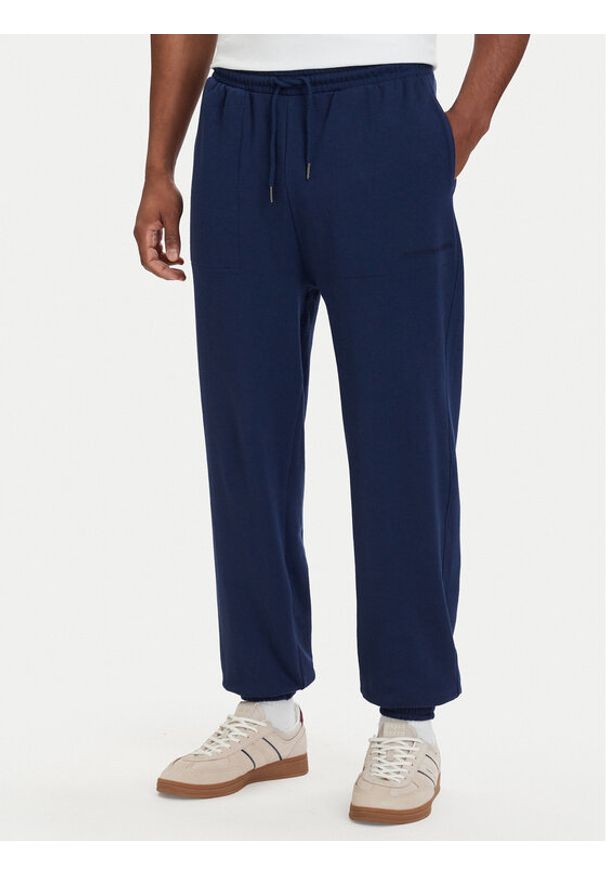 TOMMY HILFIGER - Tommy Hilfiger Spodnie dresowe Essential UM0UM03911 Granatowy Relaxed Fit. Kolor: niebieski. Materiał: bawełna