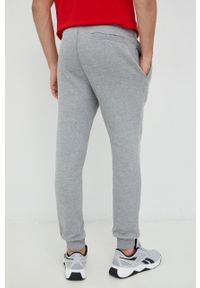 Guess spodnie dresowe kolor szary melanżowe. Kolor: szary. Materiał: dresówka. Wzór: melanż #2