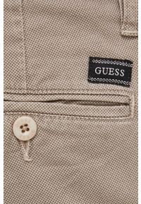Guess Spodnie męskie kolor beżowy dopasowane. Kolor: beżowy. Materiał: tkanina, materiał #3