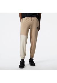 Spodnie New Balance MP21550MDY – beżowe. Kolor: beżowy. Materiał: materiał, dresówka. Sport: fitness