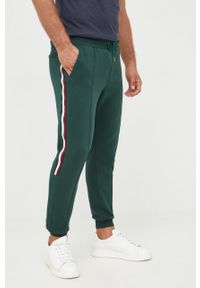 TOMMY HILFIGER - Tommy Hilfiger spodnie dresowe męskie kolor zielony z aplikacją. Kolor: zielony. Materiał: dresówka. Wzór: aplikacja #1