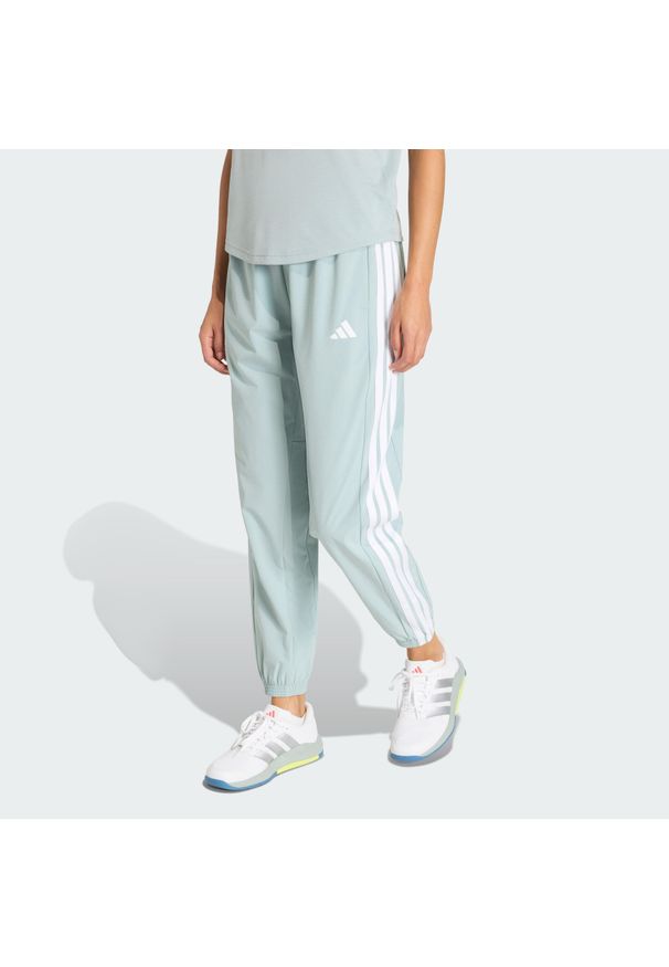 Adidas - Spodnie Train Essentials 3-Stripes Woven. Kolor: biały, wielokolorowy, zielony. Materiał: materiał. Technologia: ClimaCool (Adidas). Sport: fitness