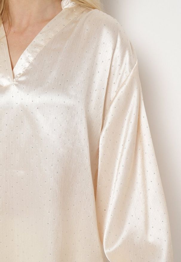 Born2be - Beżowa Satynowa Bluzka z Długim Rękawem z Trójkątnym Dekoltem i Ozdobnymi Cyrkoniami Xertantia. Okazja: do pracy, na spotkanie biznesowe. Kolor: beżowy. Materiał: satyna. Długość rękawa: długi rękaw. Długość: długie. Wzór: aplikacja. Styl: biznesowy, klasyczny