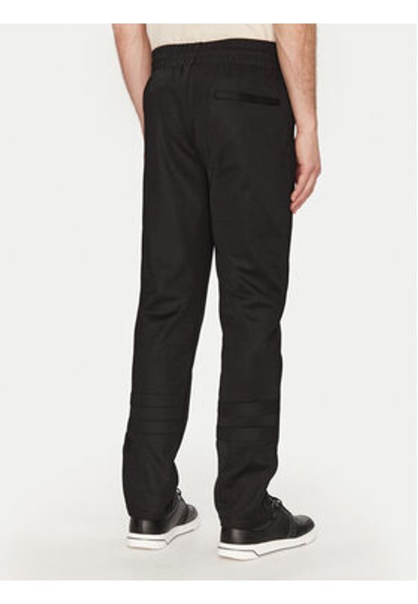 Ellesse Spodnie dresowe Palminteri SHZ22104 Czarny Regular Fit. Kolor: czarny. Materiał: syntetyk, bawełna