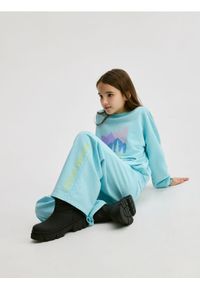 Reserved - Spodnie dresowe z nadrukiem - jasnoturkusowy. Kolor: turkusowy. Materiał: dresówka. Wzór: nadruk #1