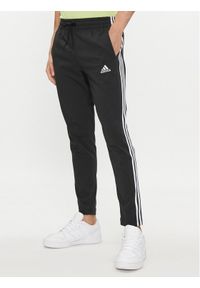Adidas - adidas Spodnie dresowe Essentials Single Jersey Tapered Open Hem 3-Stripes Joggers IC0044 Czarny Regular Fit. Kolor: czarny. Materiał: bawełna #1