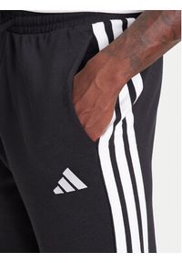 Adidas - adidas Spodnie dresowe Essential 3-Stripes JD1881 Czarny Regular Fit. Kolor: czarny. Materiał: bawełna, syntetyk #5