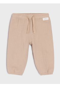 Sinsay - Bawełniane spodnie jogger - beżowy. Kolor: beżowy. Materiał: bawełna #1